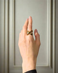 Elegant, young woman models Geometric Crossover Statement Ring, hand close up