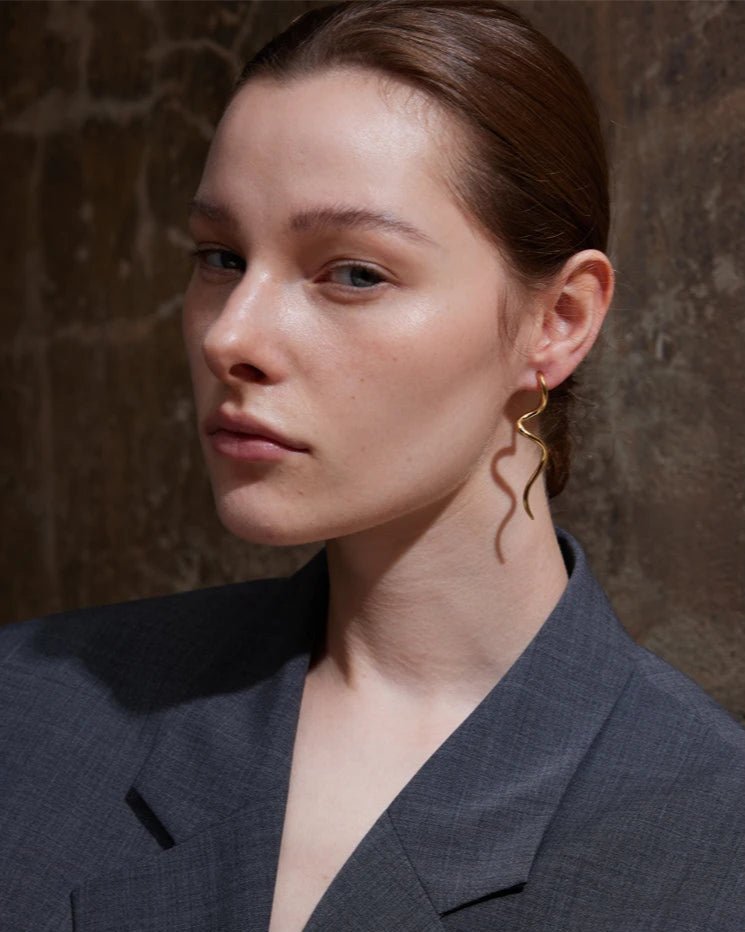 Gold Abstract Serpentine Drop Earrings, on white background