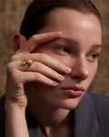 Elegant, young woman models Gold Asymmetrical Bypass Pearl Ring, close up 2