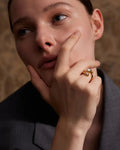 Elegant, young woman models Gold Asymmetrical Bypass Pearl Ring, close up 3