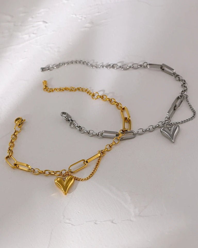 Gold and Silver Asymmetrical Heart Charm Bracelet on surface display