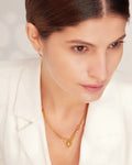 Elegant woman modeling Gold Asymmetrical Heart Charm Necklace, left close up