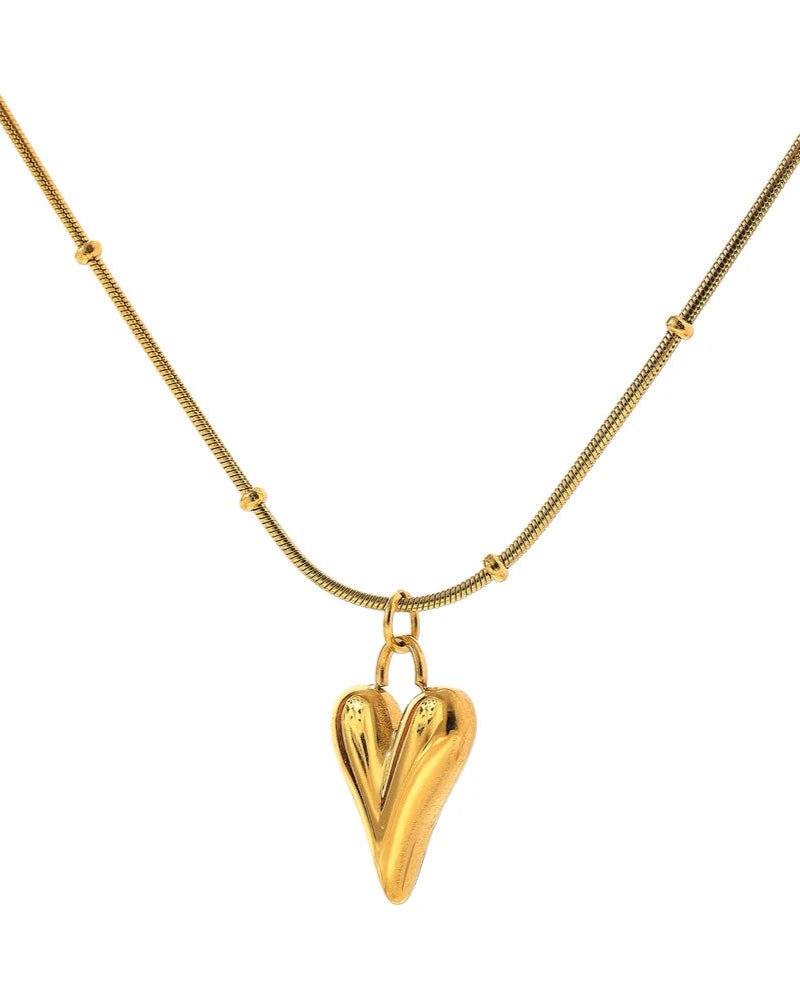 Gold Asymmetrical Heart Pendant Necklace, station chain variant, on white background