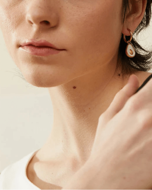 Stylish young woman models Avocado Sculpted Drop Earrings, angle 2