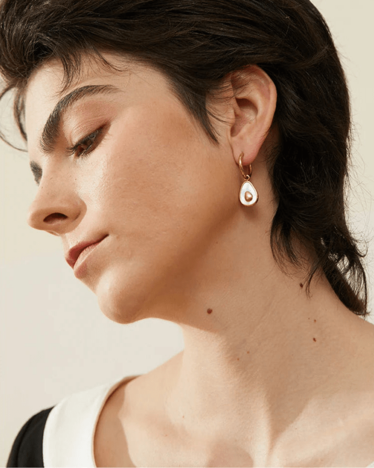 Stylish young woman models Avocado Sculpted Drop Earrings, angle 3