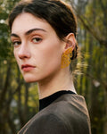 Elegant, young woman models Gold Butterfly Wing Statement Earrings, angle 3