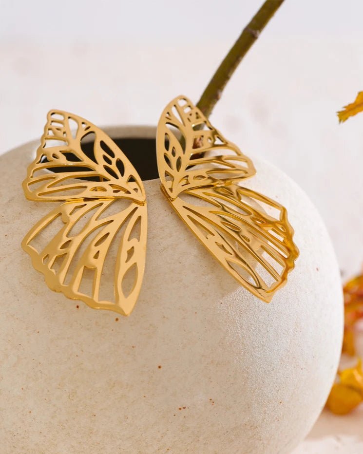 Gold Butterfly Wing Statement Earrings, on display