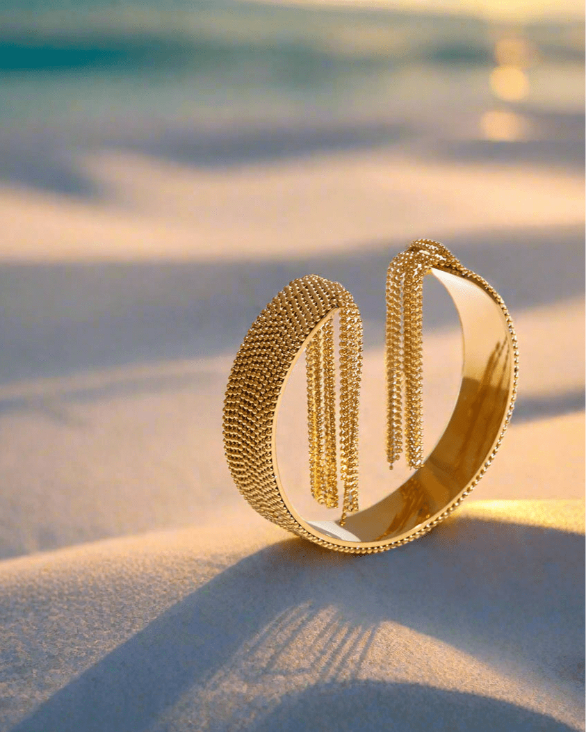 Gold Cascading Ball Chain Cuff Bracelet, on displayed on the sand by the beach