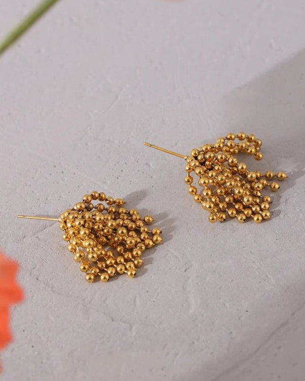 Gold Cascading Ball Chain Drop Earrings on display table