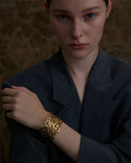 Elegant, young woman models Gold Coral Motif Statement Cuff, angle 3