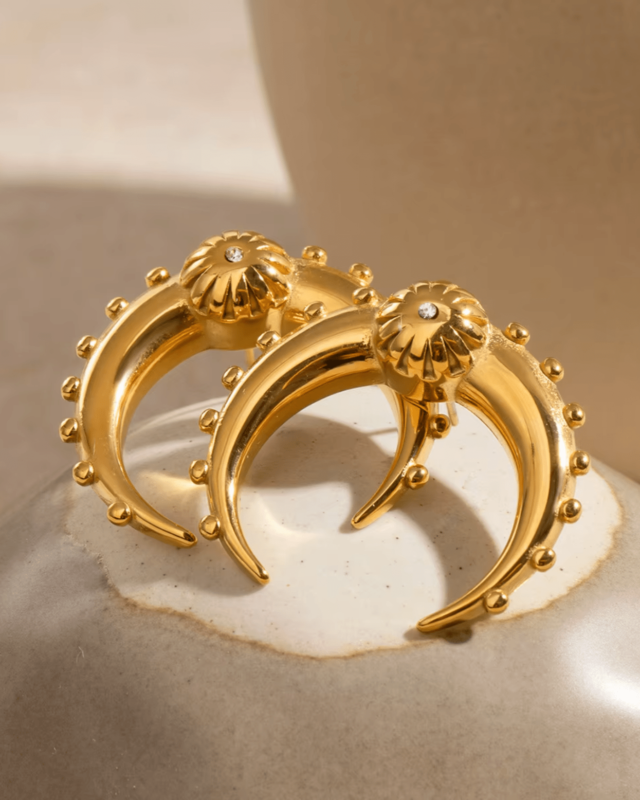Gold Crescent Moon Earrings on display 1