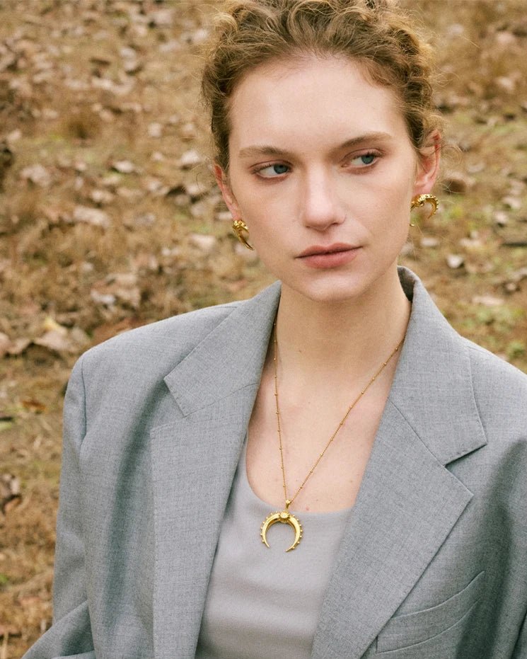 Stylish young woman models old Crescent Moon Earrings, portrait 