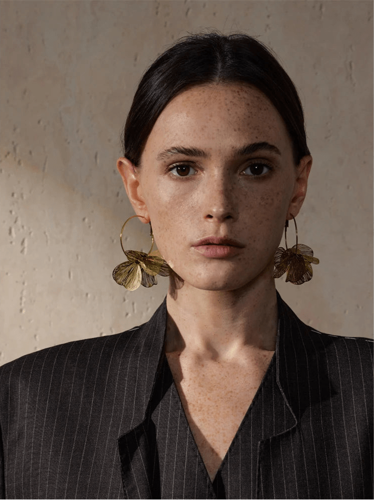 Flower Motif Hoop Earrings against white background