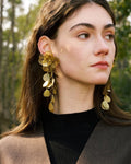 Elegant, young woman, models Gold Flower Motif Statement Earrings, angle 3