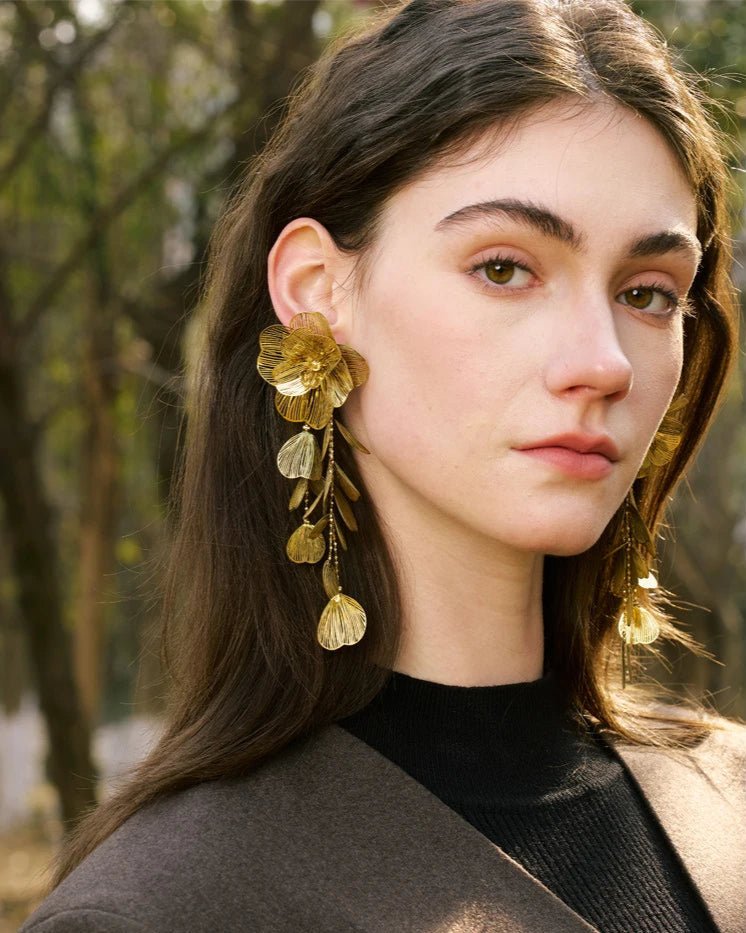 Elegant, young woman, models Gold Flower Motif Statement Earrings, angle 1