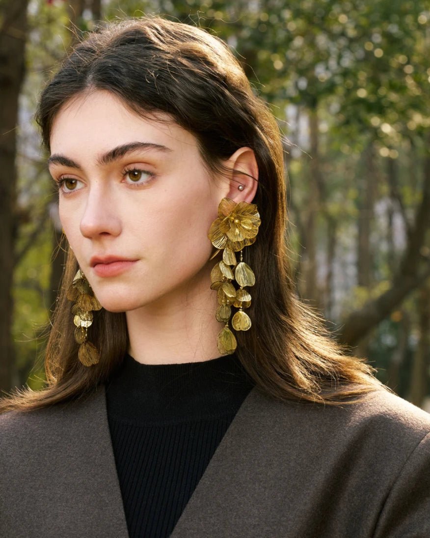 Elegant, young woman, models Gold Flower Motif Statement Earrings, angle 2