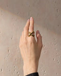 Elegant, young woman models Geometric Crossover Statement Ring, hand close up