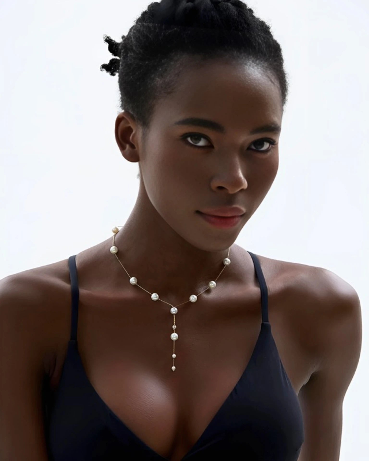 Stylish woman models Station Pearl Lariat Necklace angle 2